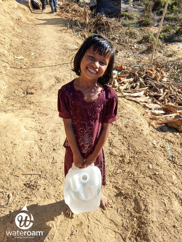 Happy girl with clean, filtered drinking water