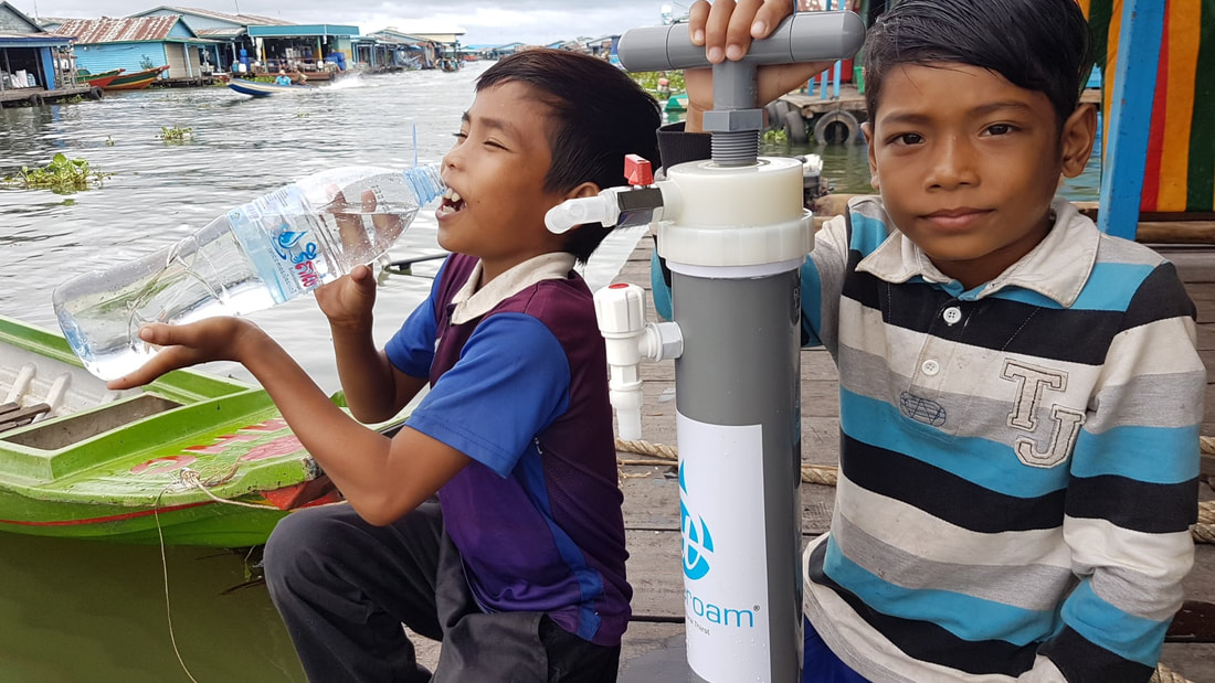 Two happy young boys who are enjoying clean drinking water from Wateroam's ROAMfilter Plus