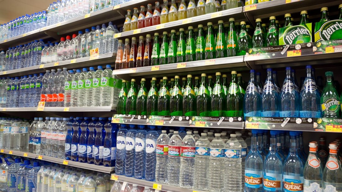 Shelves in the supermarket filled with bottles of water that is safe for human consumption