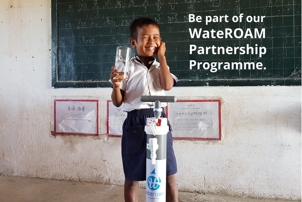 A happy school boy drinking safe and clean drinking water from the ROAMfilter Plus