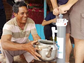 One happy villager getting clean drinking water from ROAMfilter™ Plus